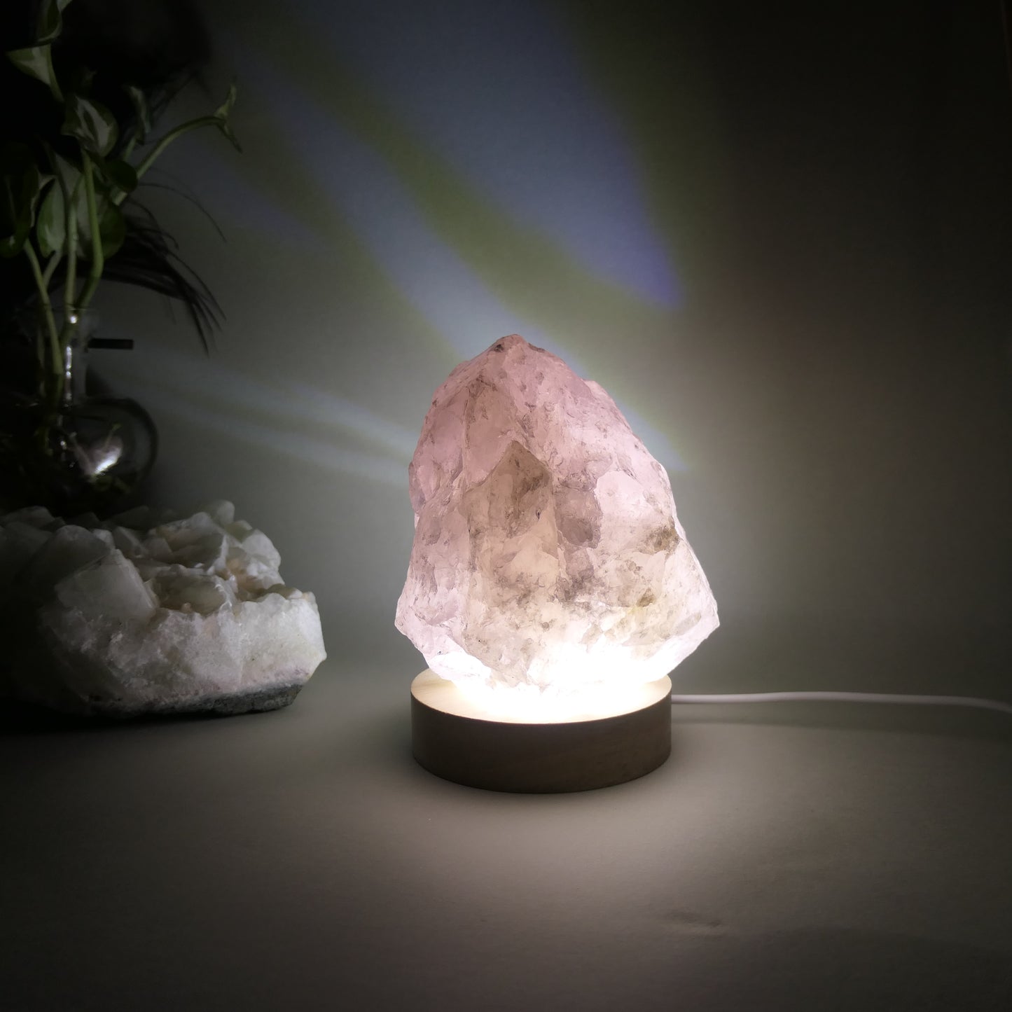1kg Rose Quratz Cut base sitting on 8mm wooden LED white light base that is turned on